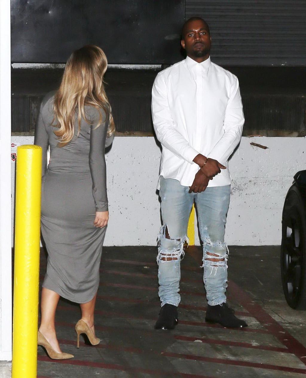 16P Kim Kardashian showing big cleavage in a high slit gray dress outside Dash bouti