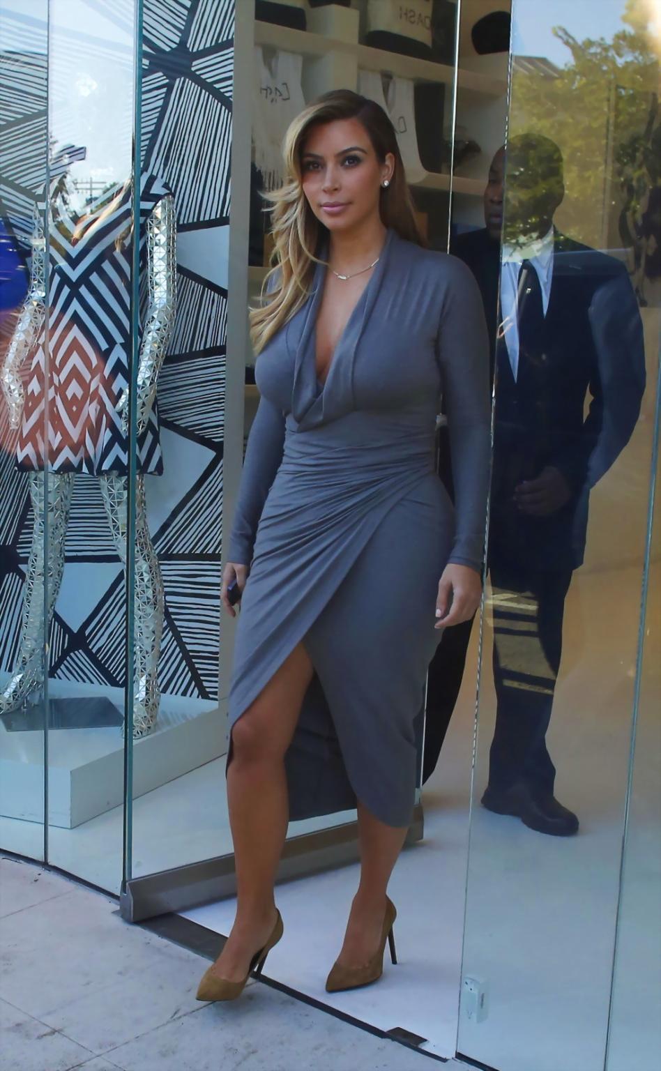 16P Kim Kardashian showing big cleavage in a high slit gray dress outside Dash bouti