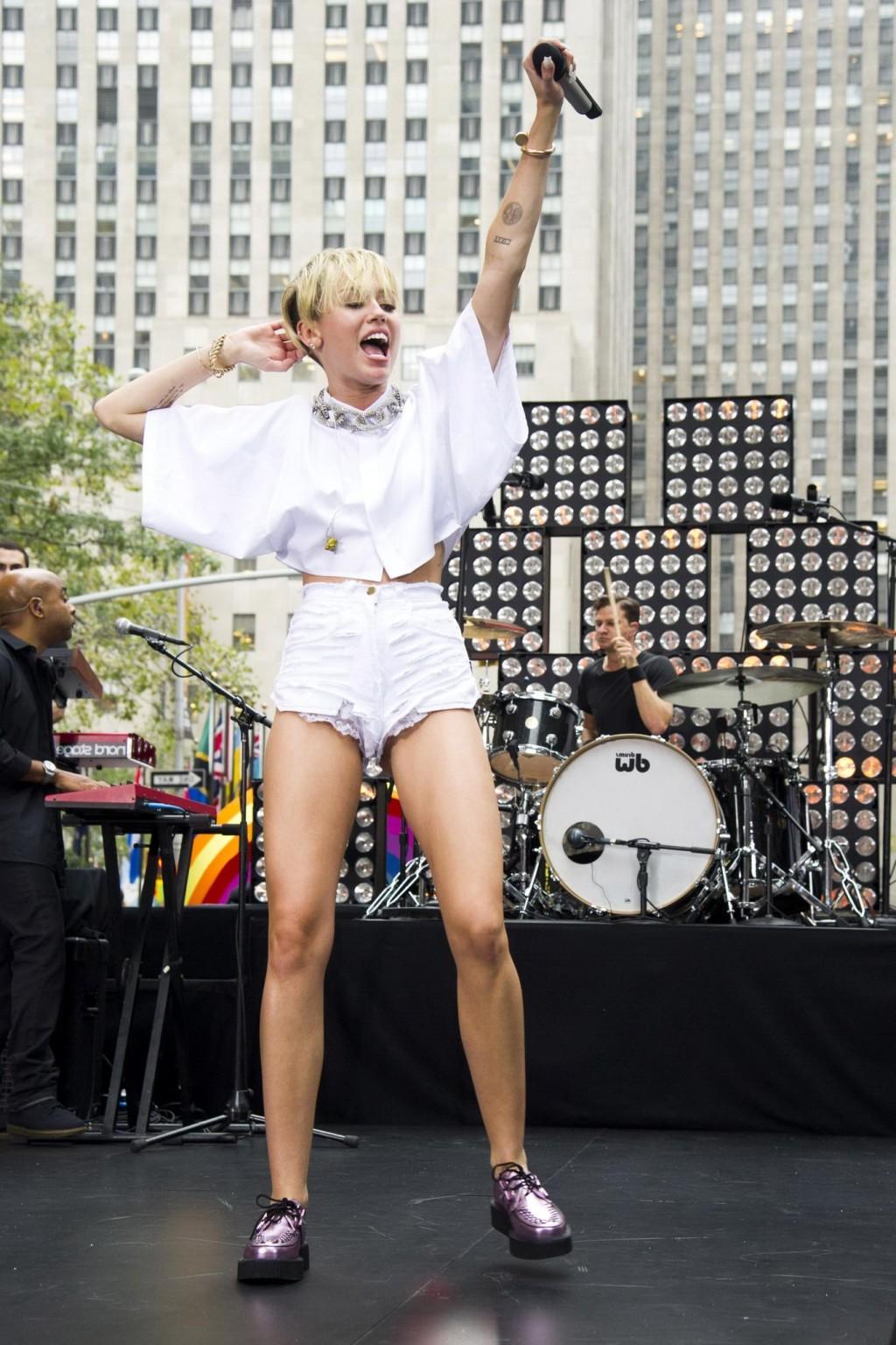 16P Miley Cyrus showing off her ass, legs and panties while performing in ripped hot