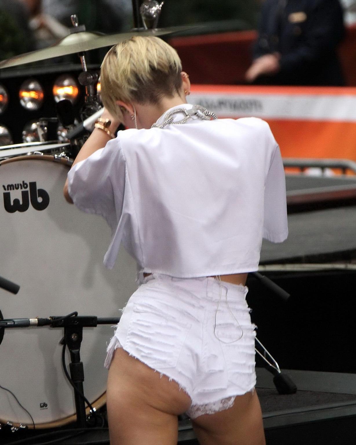 16P Miley Cyrus showing off her ass, legs and panties while performing in ripped hot