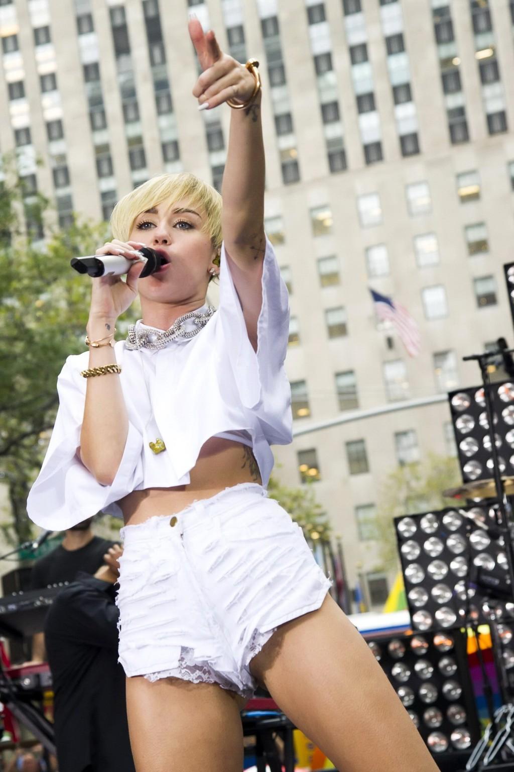 16P Miley Cyrus showing off her ass, legs and panties while performing in ripped hot