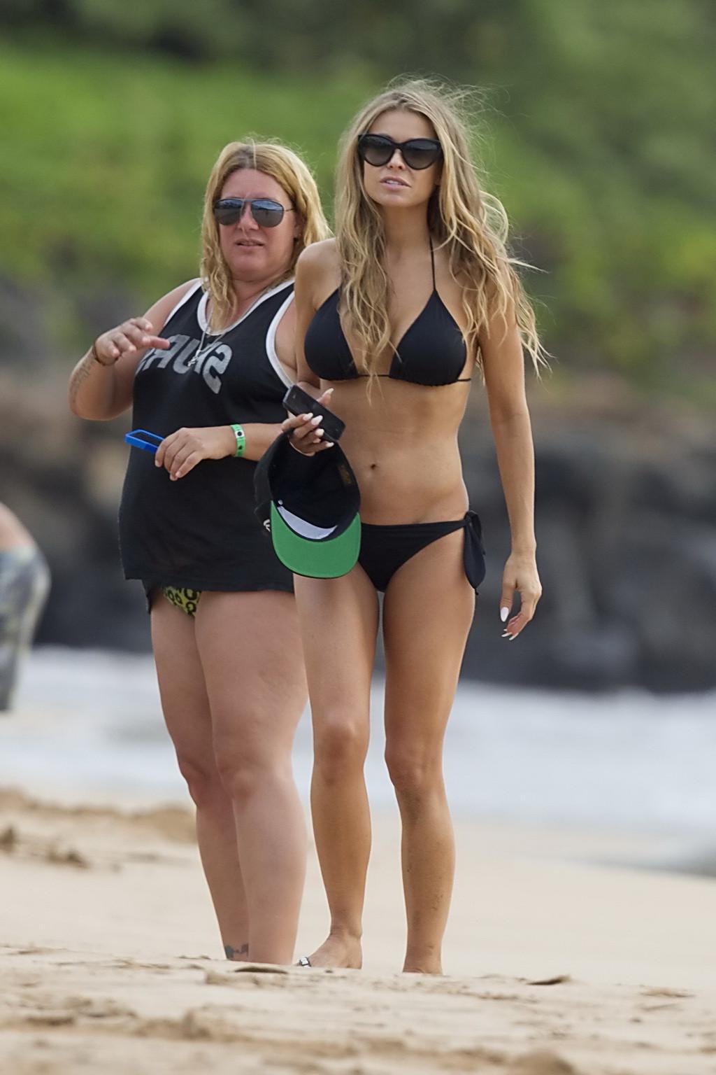 16P Carmen Electra showing off her curvy body in a black string bikini at the beach 