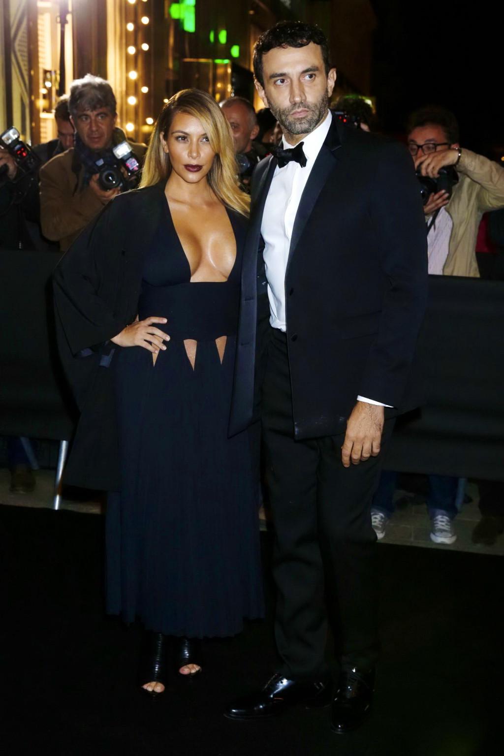 16P Kim Kardashian braless showing huge cleavage in a low cut black dress at the Mad