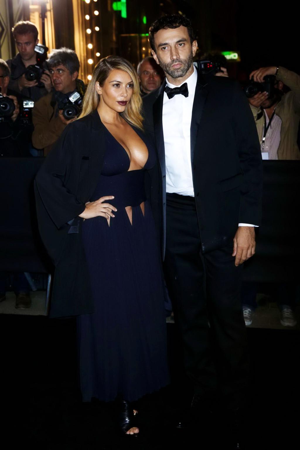 16P Kim Kardashian braless showing huge cleavage in a low cut black dress at the Mad