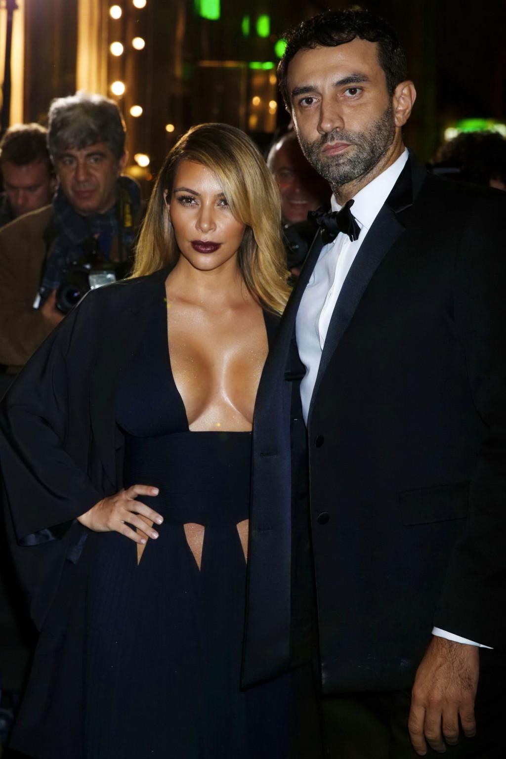 16P Kim Kardashian braless showing huge cleavage in a low cut black dress at the Mad