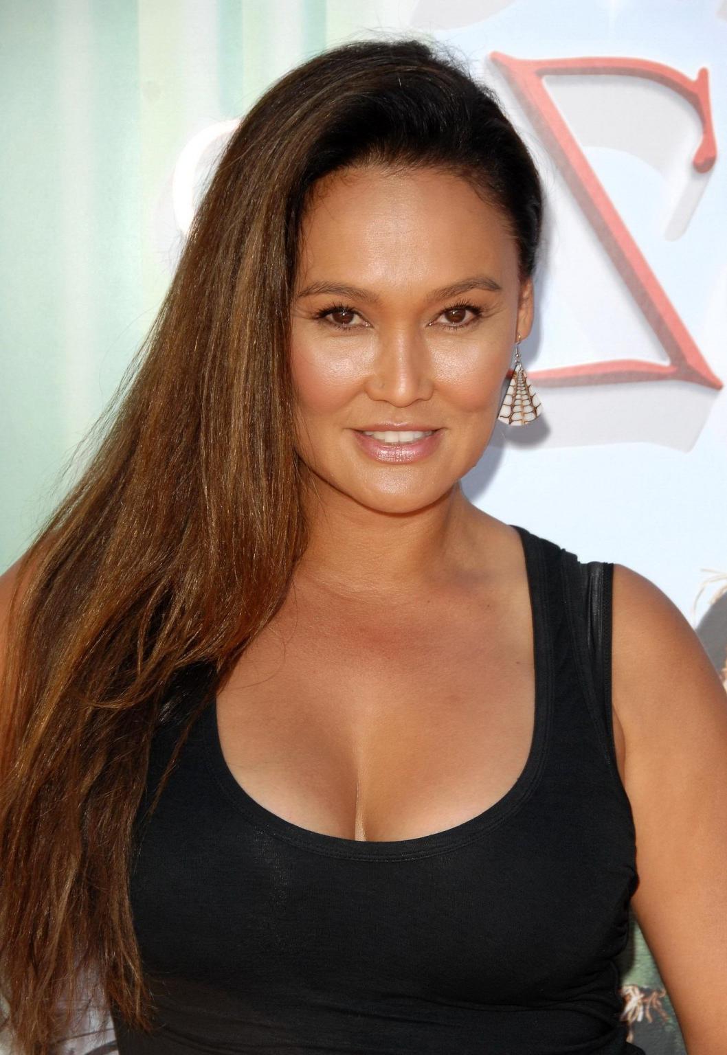 16P Busty Tia Carrere wearing a tight black dress at 'The Wizard Of Oz 3D' premiere 