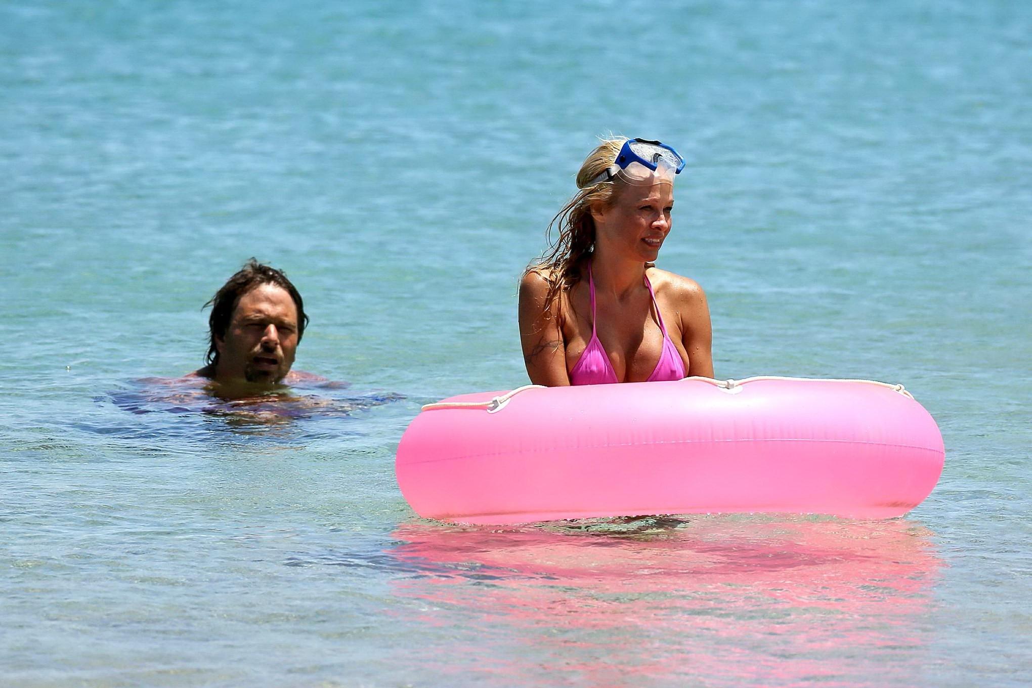 16P Busty Pamela Anderson showing pokies in a wet pink bikini while snorkeling on a 
