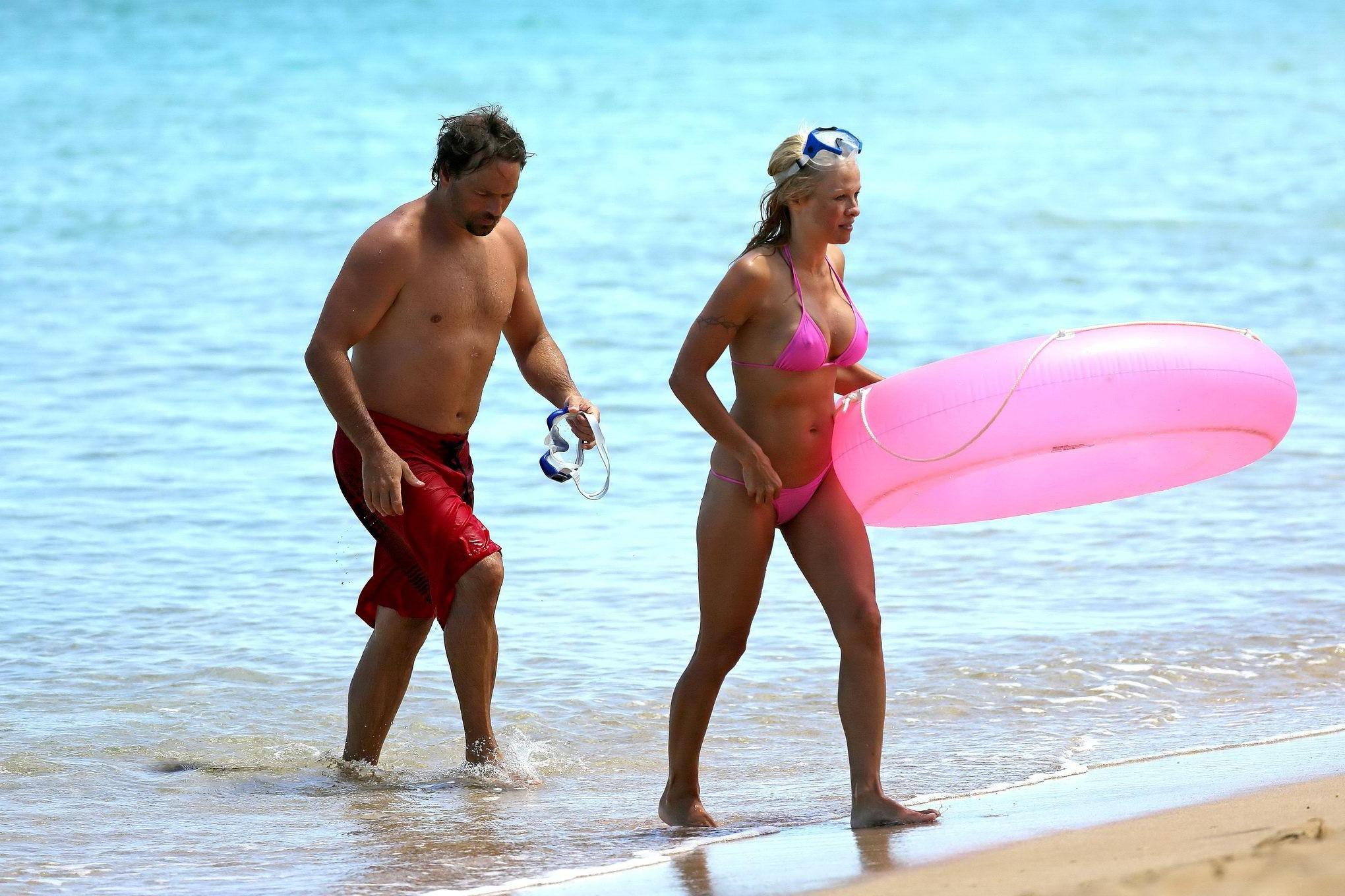 16P Busty Pamela Anderson showing pokies in a wet pink bikini while snorkeling on a 