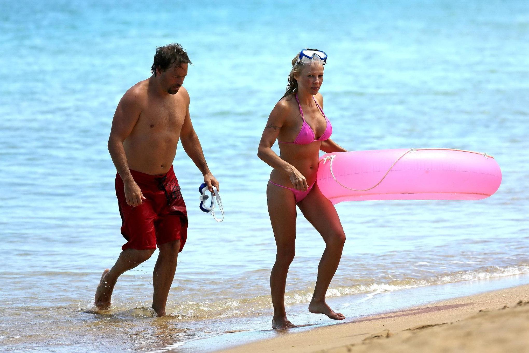 16P Busty Pamela Anderson showing pokies in a wet pink bikini while snorkeling on a 