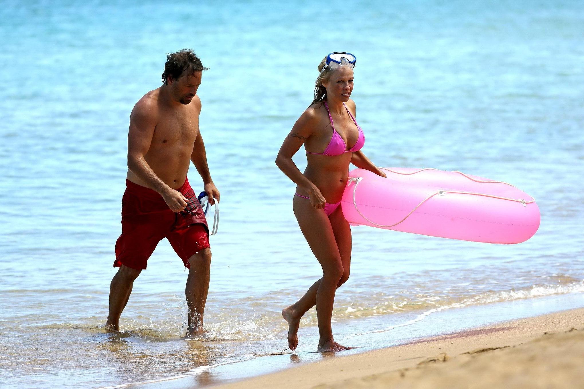 16P Busty Pamela Anderson showing pokies in a wet pink bikini while snorkeling on a 