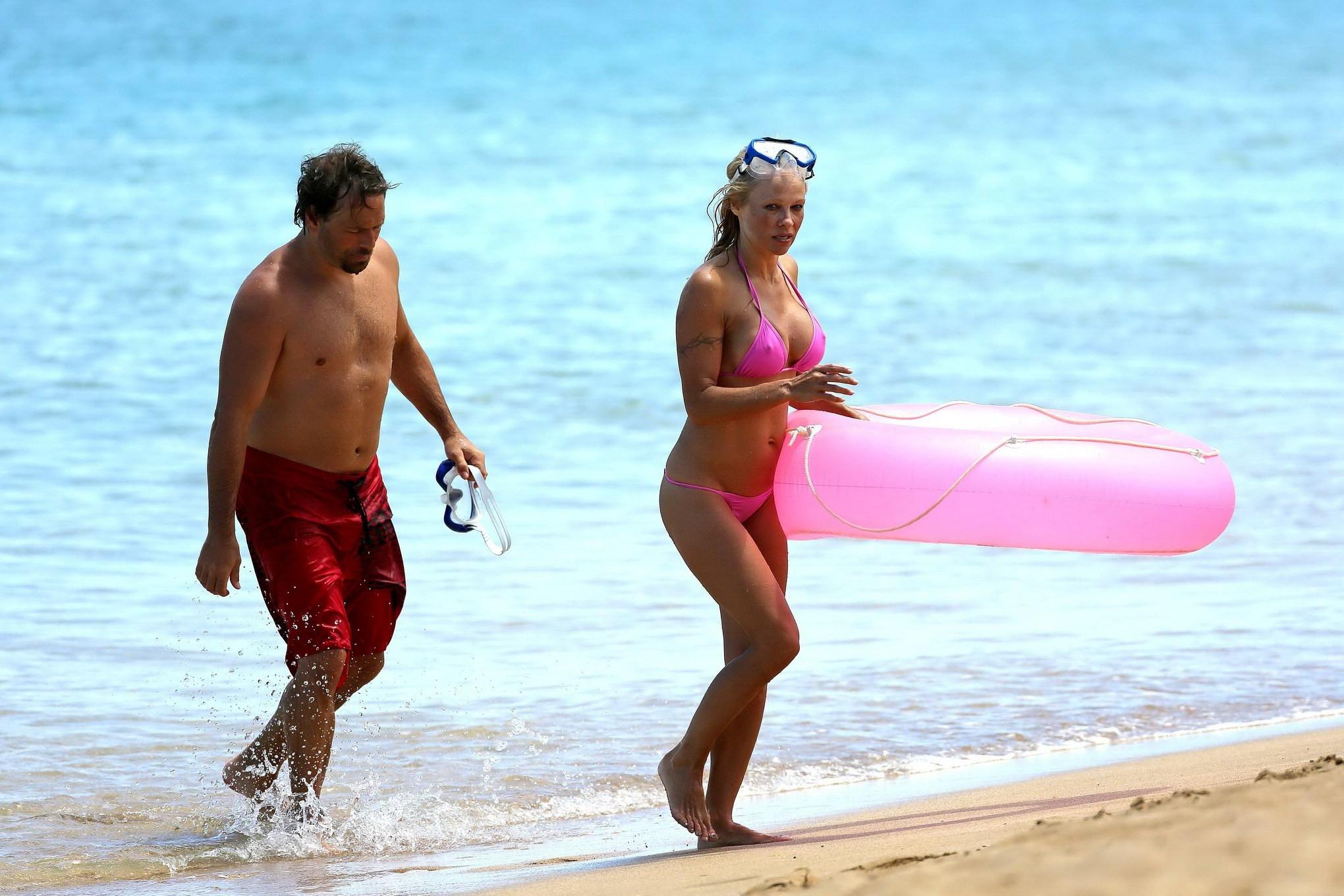 16P Busty Pamela Anderson showing pokies in a wet pink bikini while snorkeling on a 