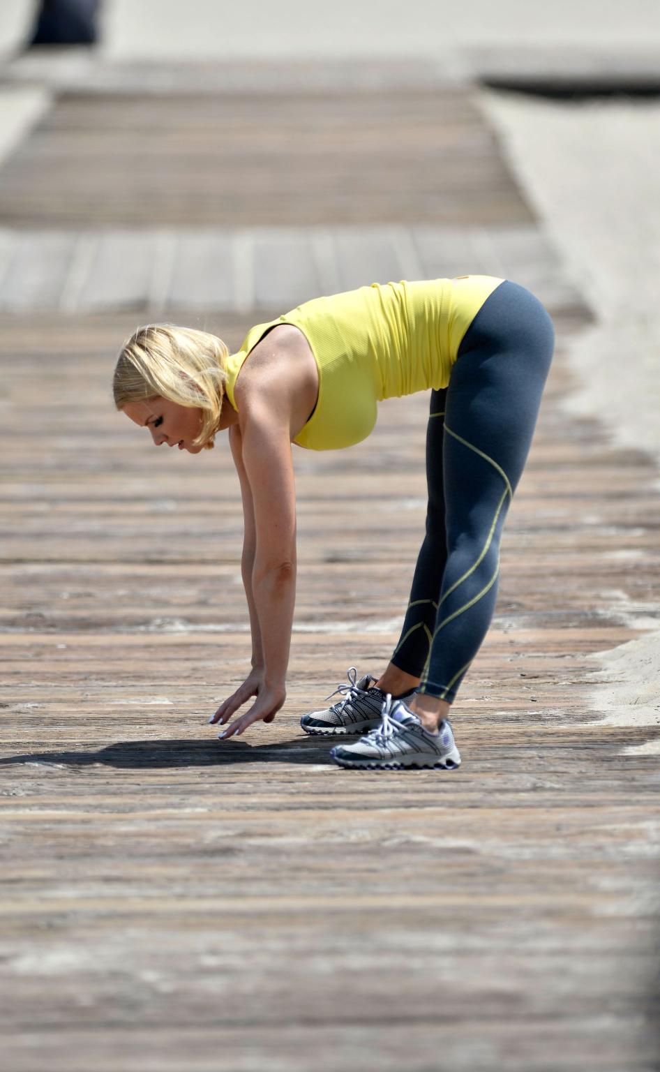 16P Carrie Keagan showing huge cleavage in yellow tank top and tights while working 