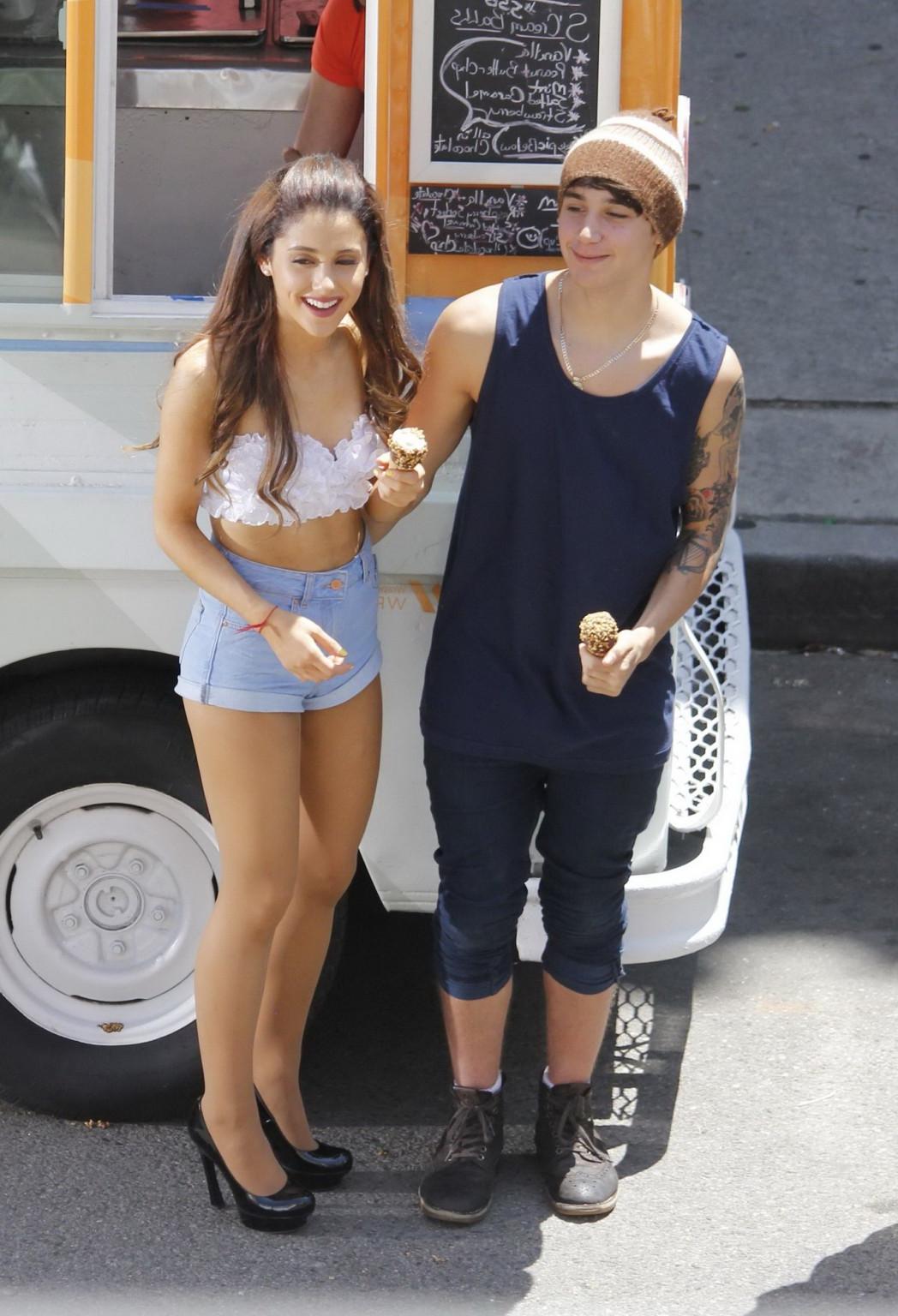 16P Ariana Grande wearing white bikini top and denim shorts while filming her new mu