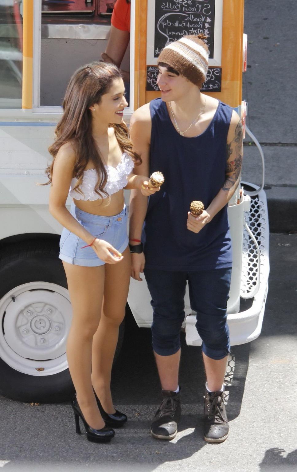 16P Ariana Grande wearing white bikini top and denim shorts while filming her new mu