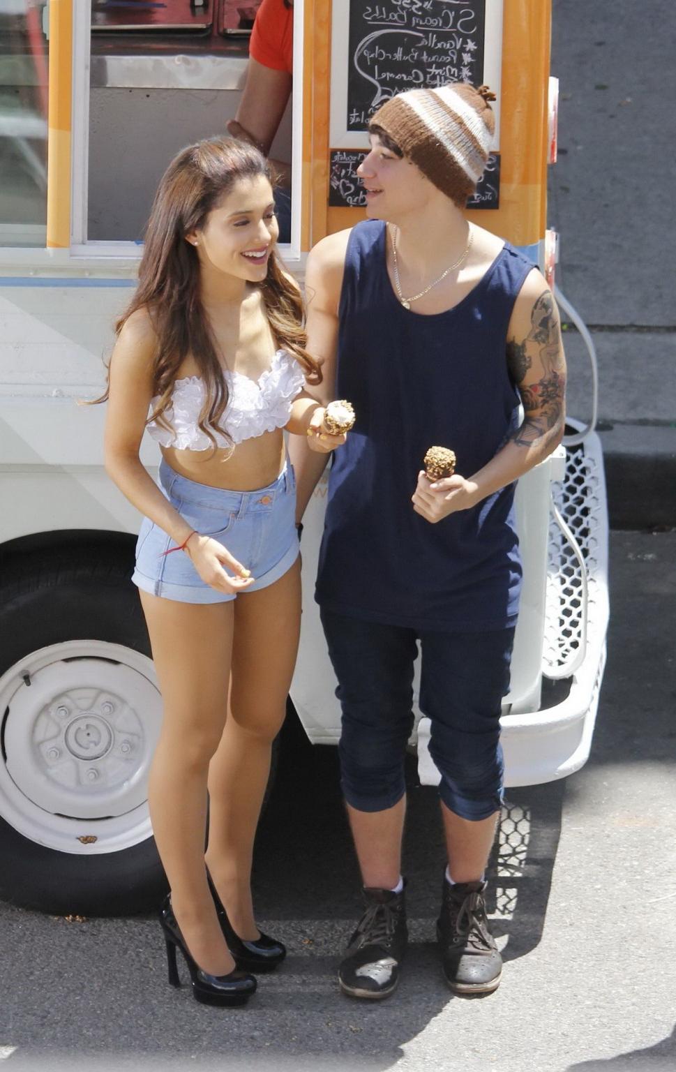 16P Ariana Grande wearing white bikini top and denim shorts while filming her new mu