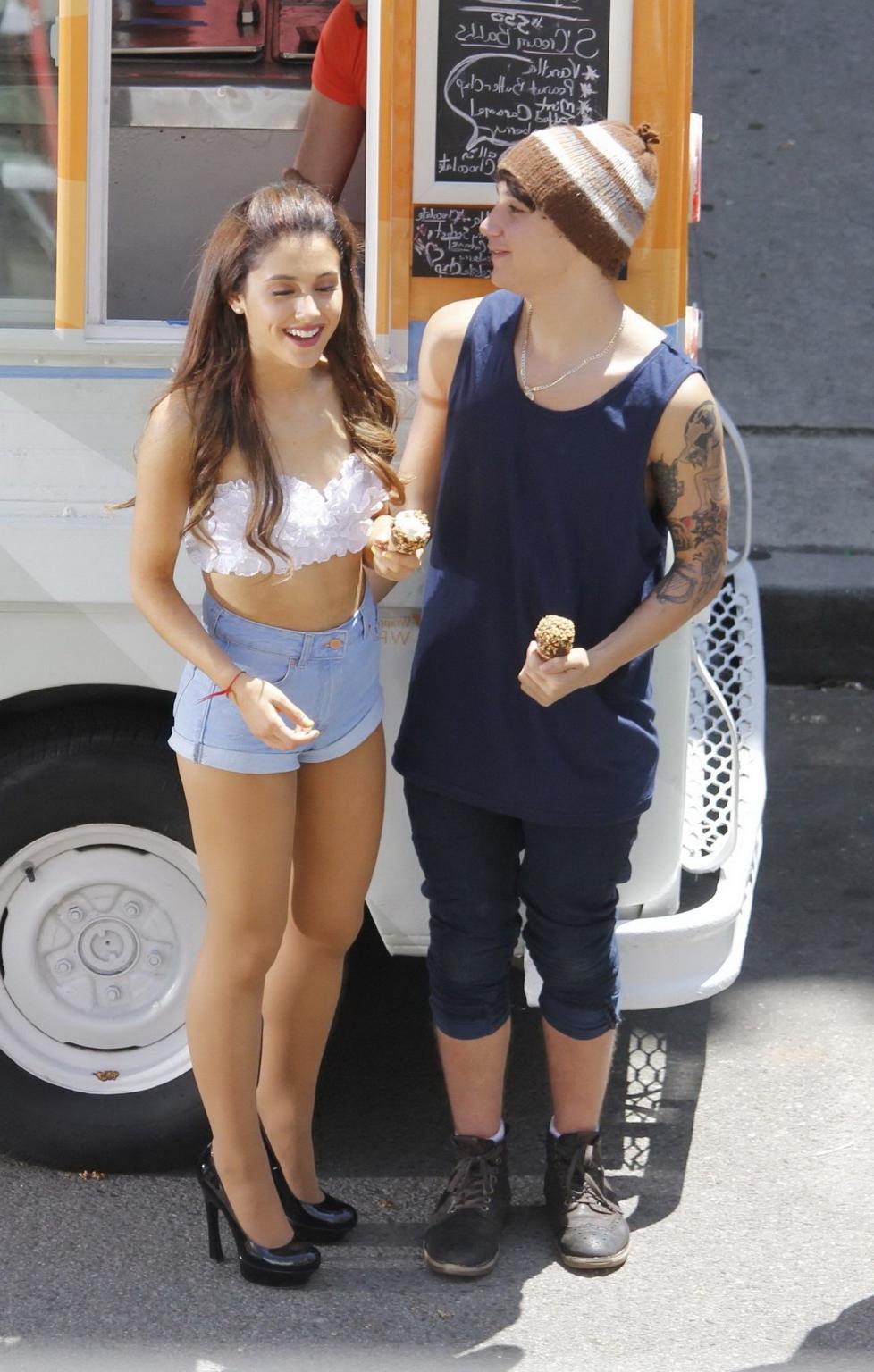 16P Ariana Grande wearing white bikini top and denim shorts while filming her new mu