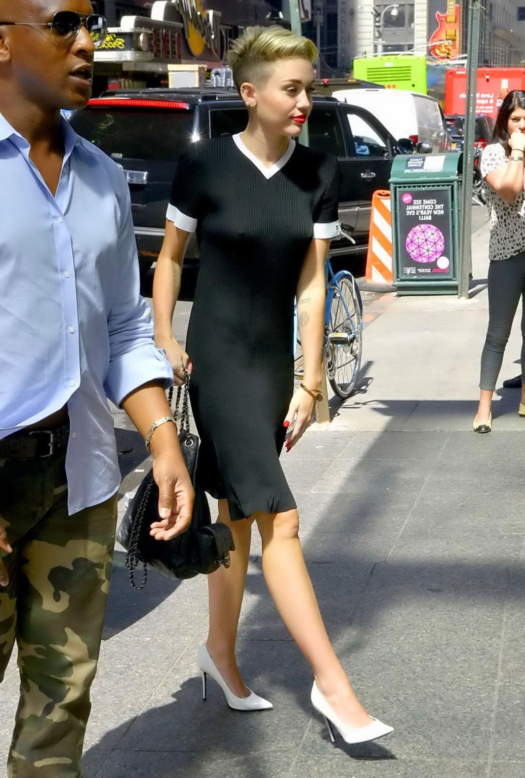 16P Miley Cyrus flashing her boobs braless in black transparent dress out in NYC