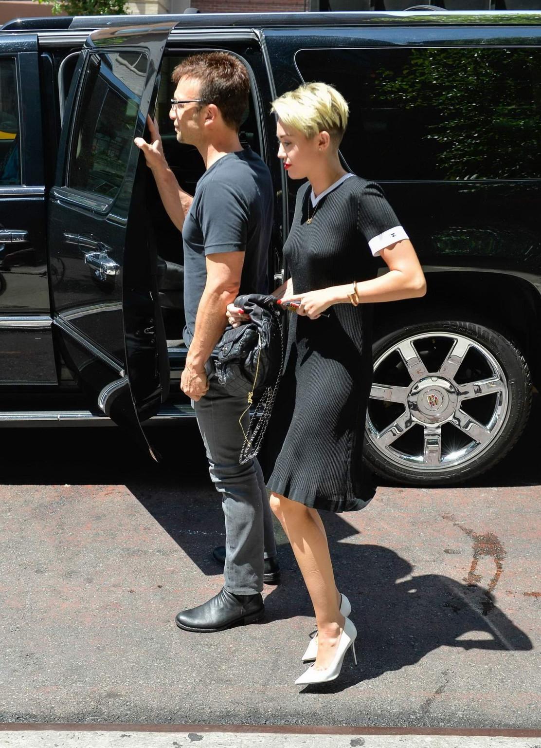 16P Miley Cyrus flashing her boobs braless in black transparent dress out in NYC