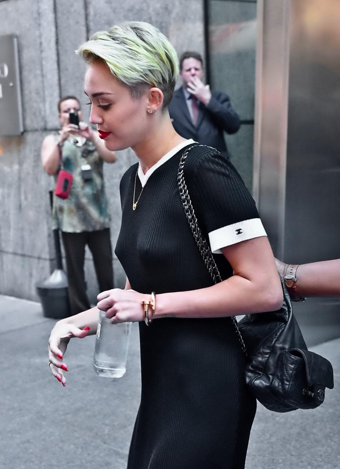 16P Miley Cyrus flashing her boobs braless in black transparent dress out in NYC