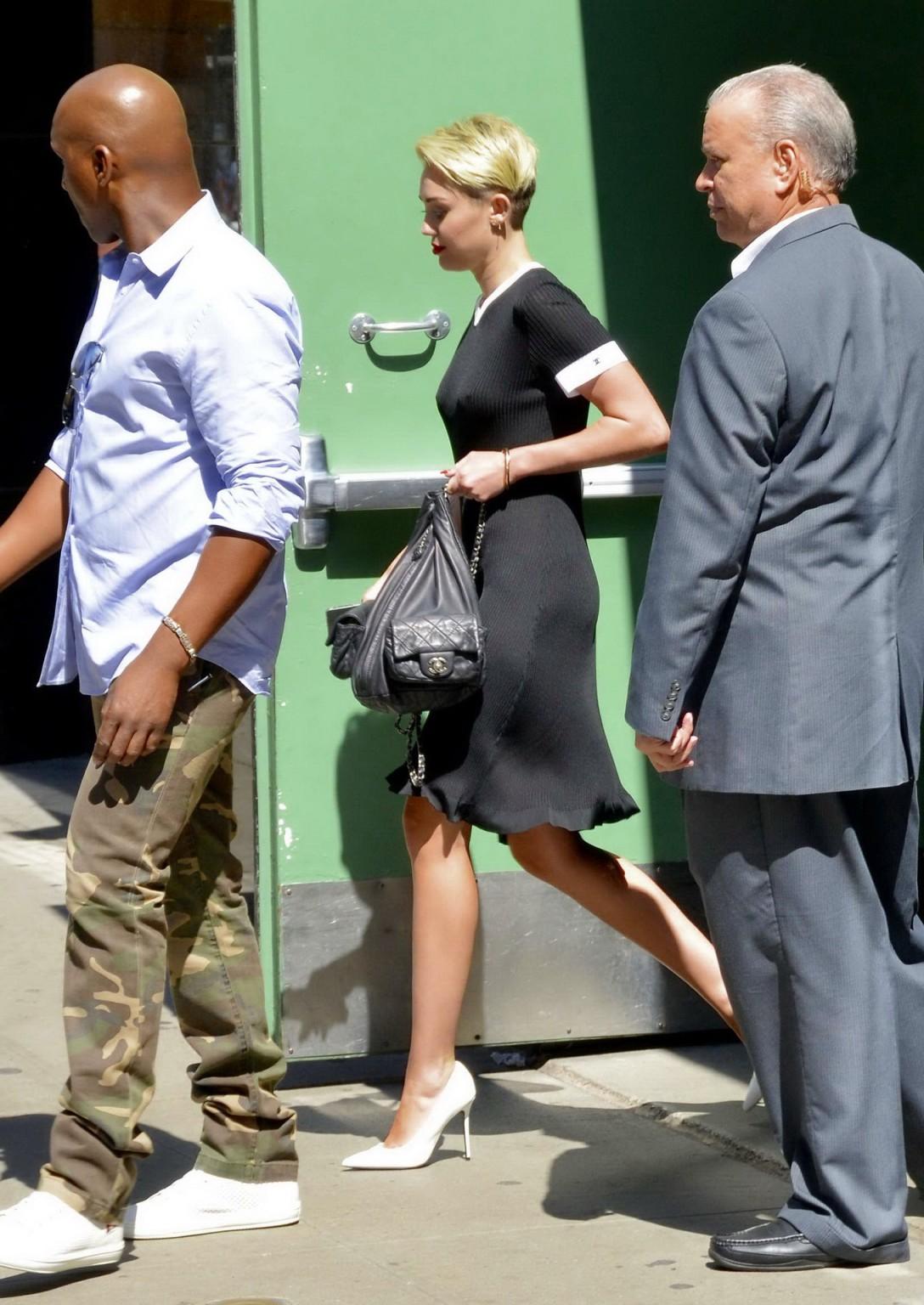 16P Miley Cyrus flashing her boobs braless in black transparent dress out in NYC