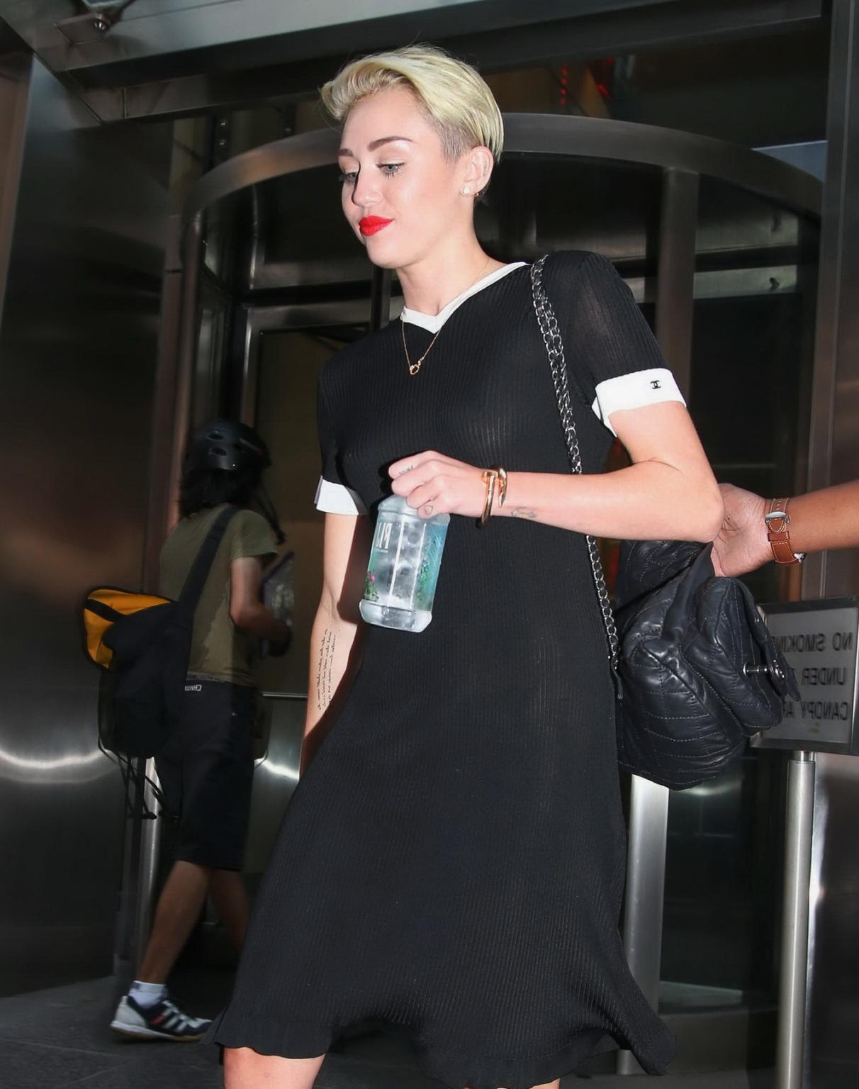 16P Miley Cyrus flashing her boobs braless in black transparent dress out in NYC