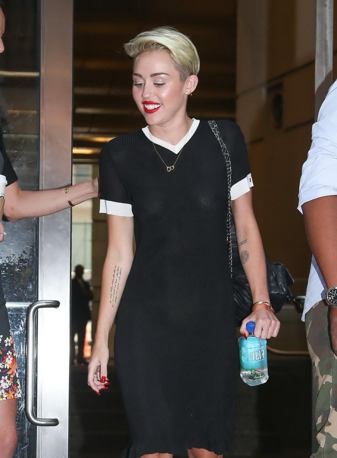 16P Miley Cyrus flashing her boobs braless in black transparent dress out in NYC