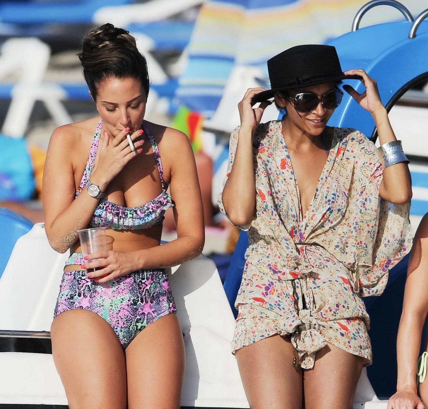 16P Tulisa Contostavlos drinks champagne from a bottle wearing skimpy colorful retro