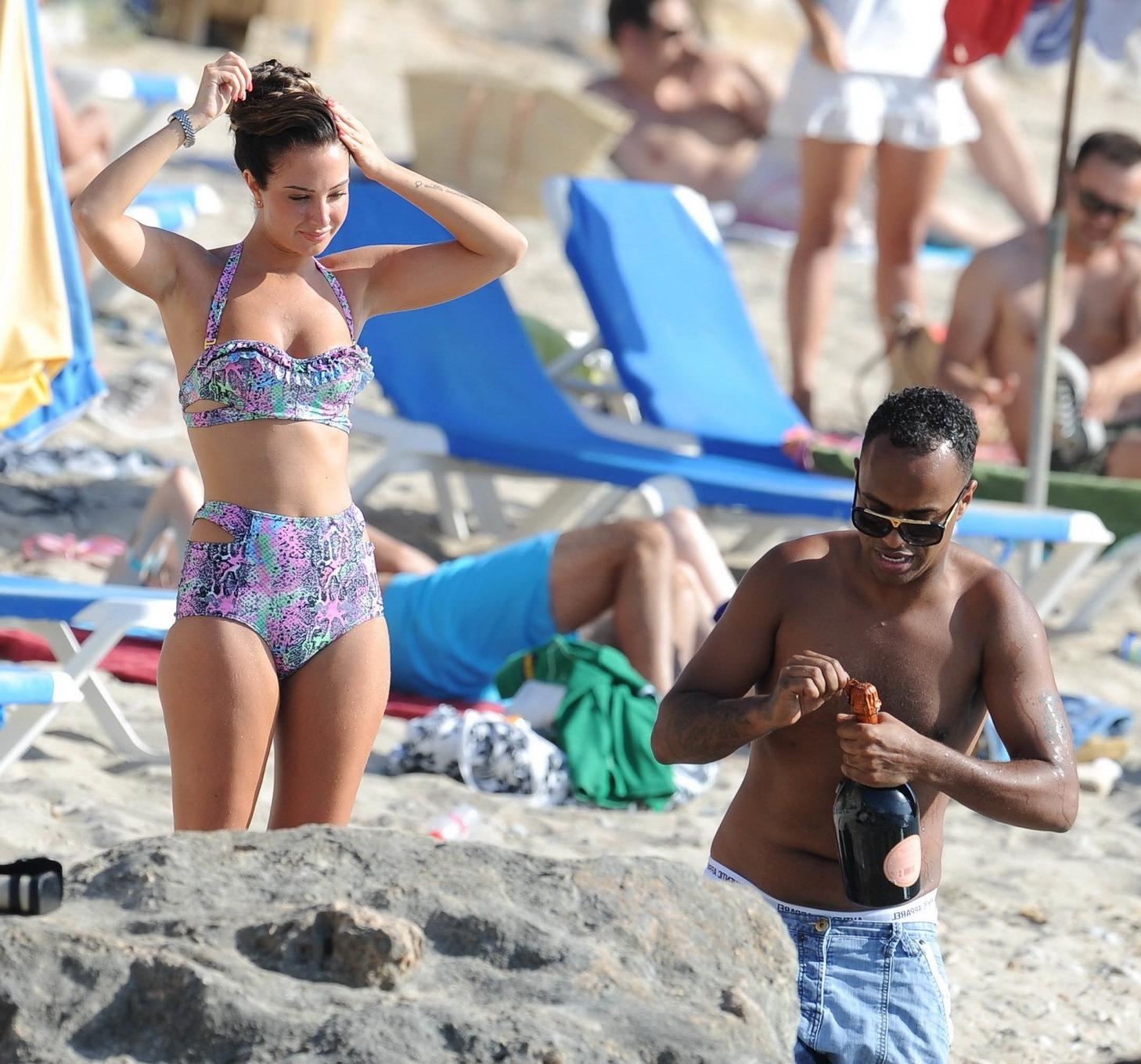 16P Tulisa Contostavlos drinks champagne from a bottle wearing skimpy colorful retro