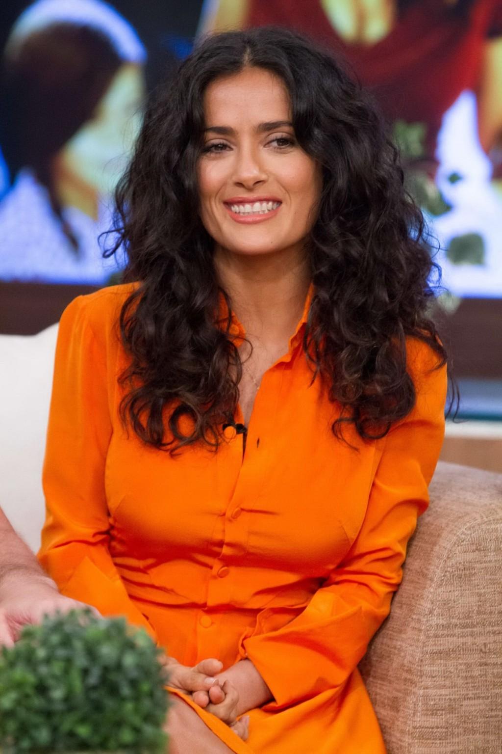 16P Salma Hayek upskirt wearing short orange dress at Despierta America Show in Miam