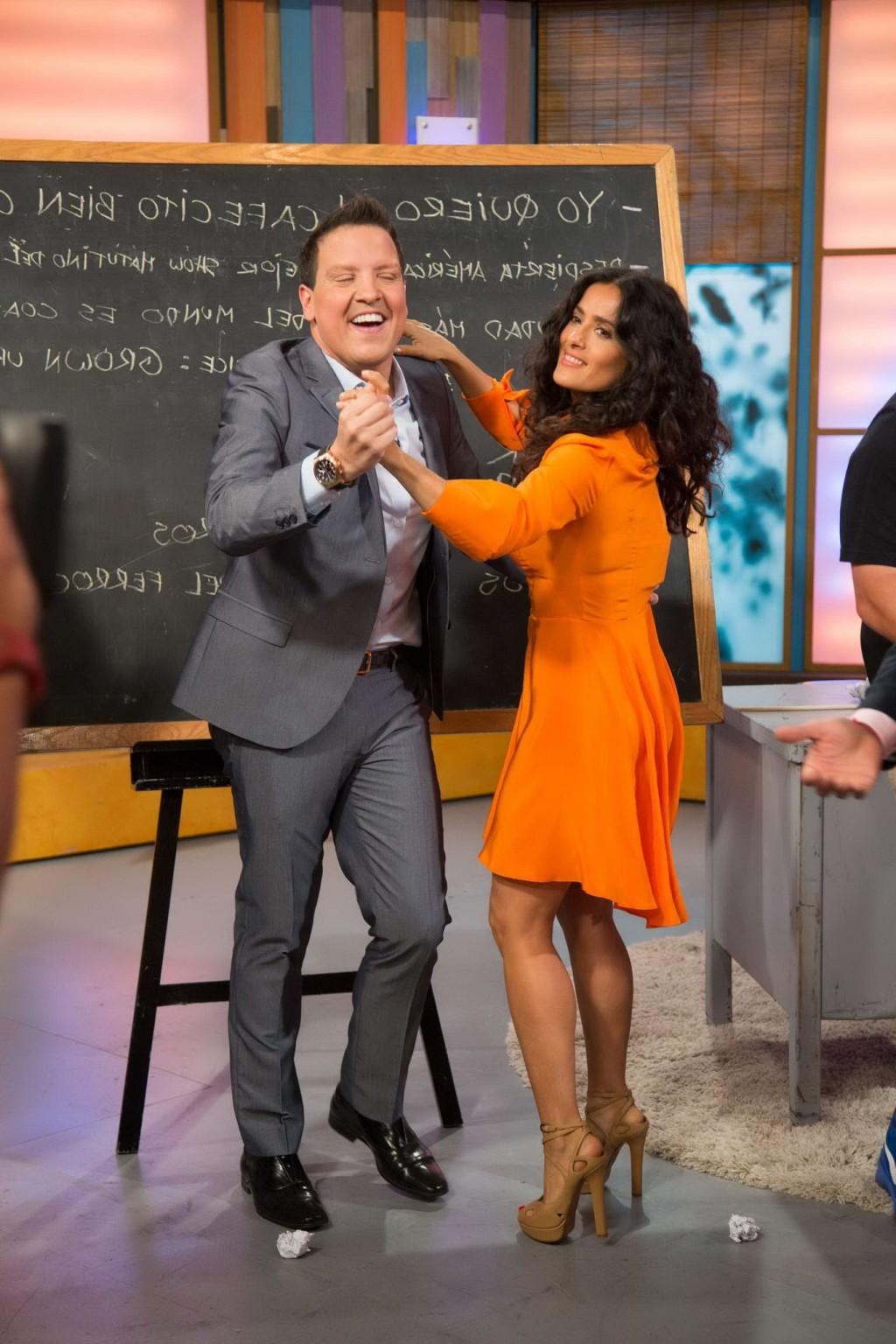 16P Salma Hayek upskirt wearing short orange dress at Despierta America Show in Miam