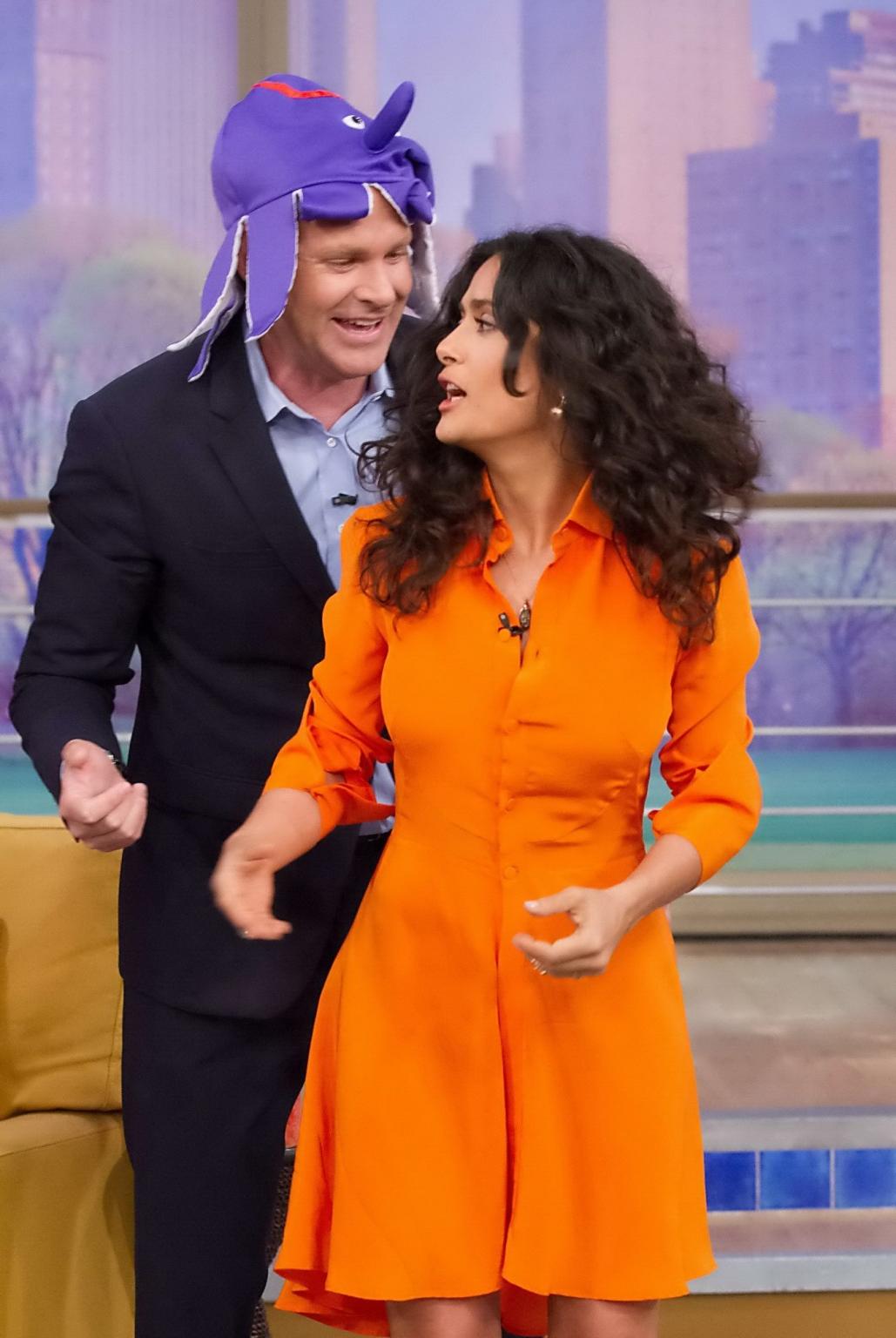 16P Salma Hayek upskirt wearing short orange dress at Despierta America Show in Miam