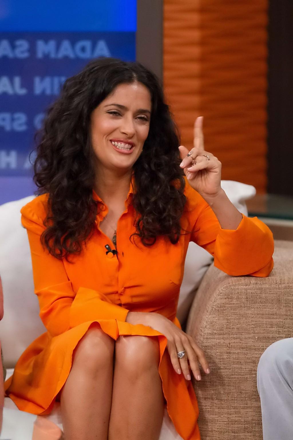 16P Salma Hayek upskirt wearing short orange dress at Despierta America Show in Miam