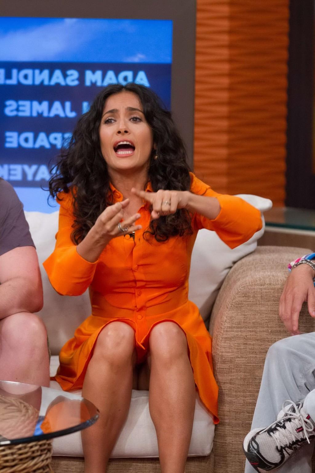 16P Salma Hayek upskirt wearing short orange dress at Despierta America Show in Miam
