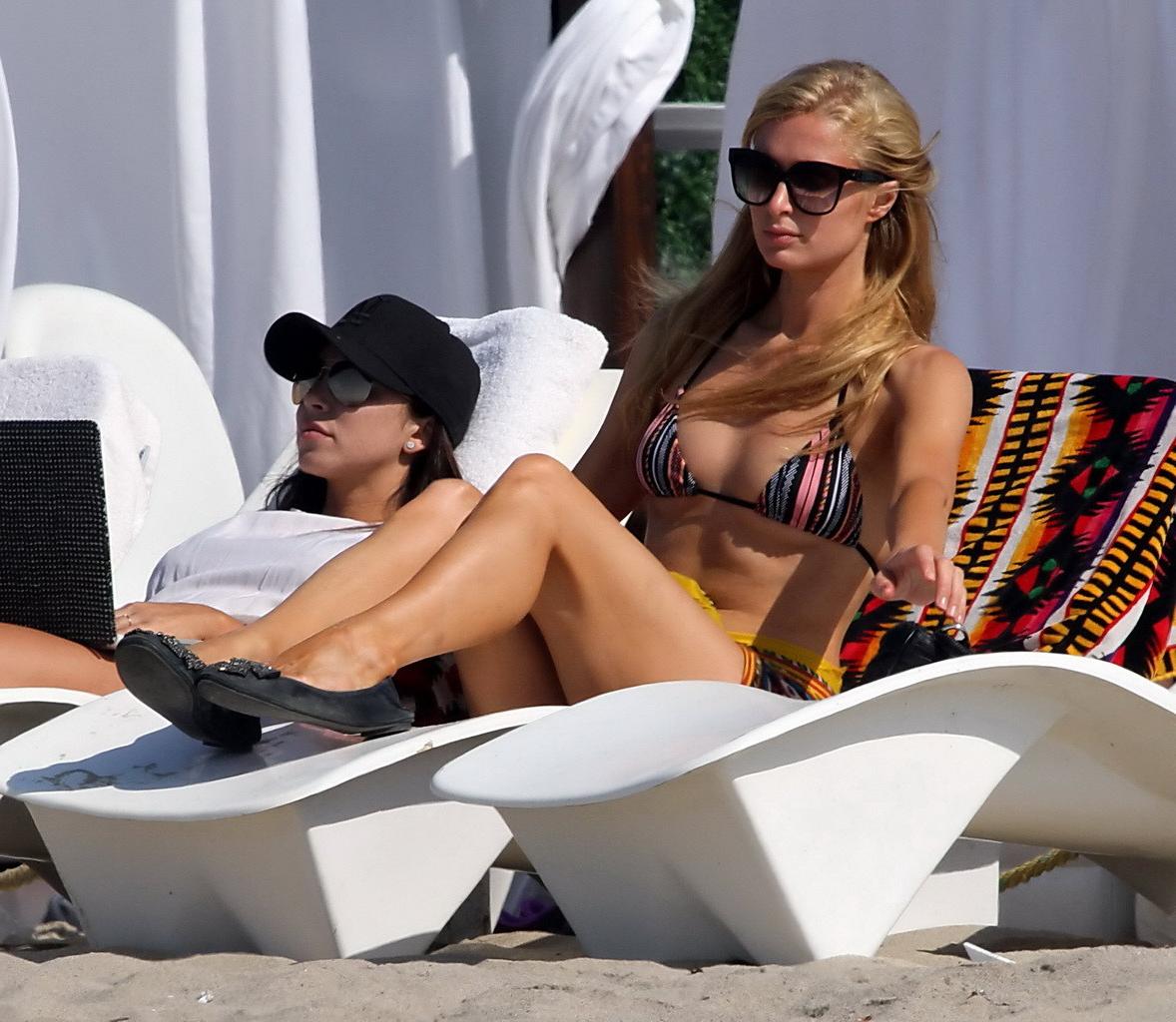 16P Paris Hilton shows off her hot body wearing tiny striped bikini at the beach in 