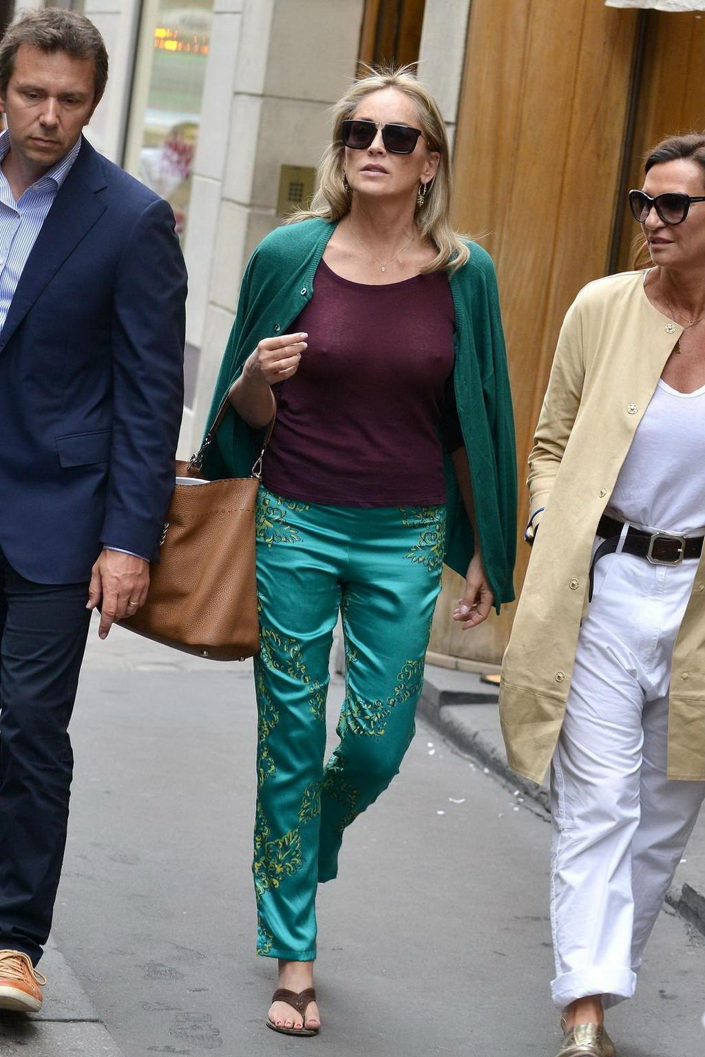 16P Sharon Stone showing off her huge boobs in a purple see-through top out in Paris