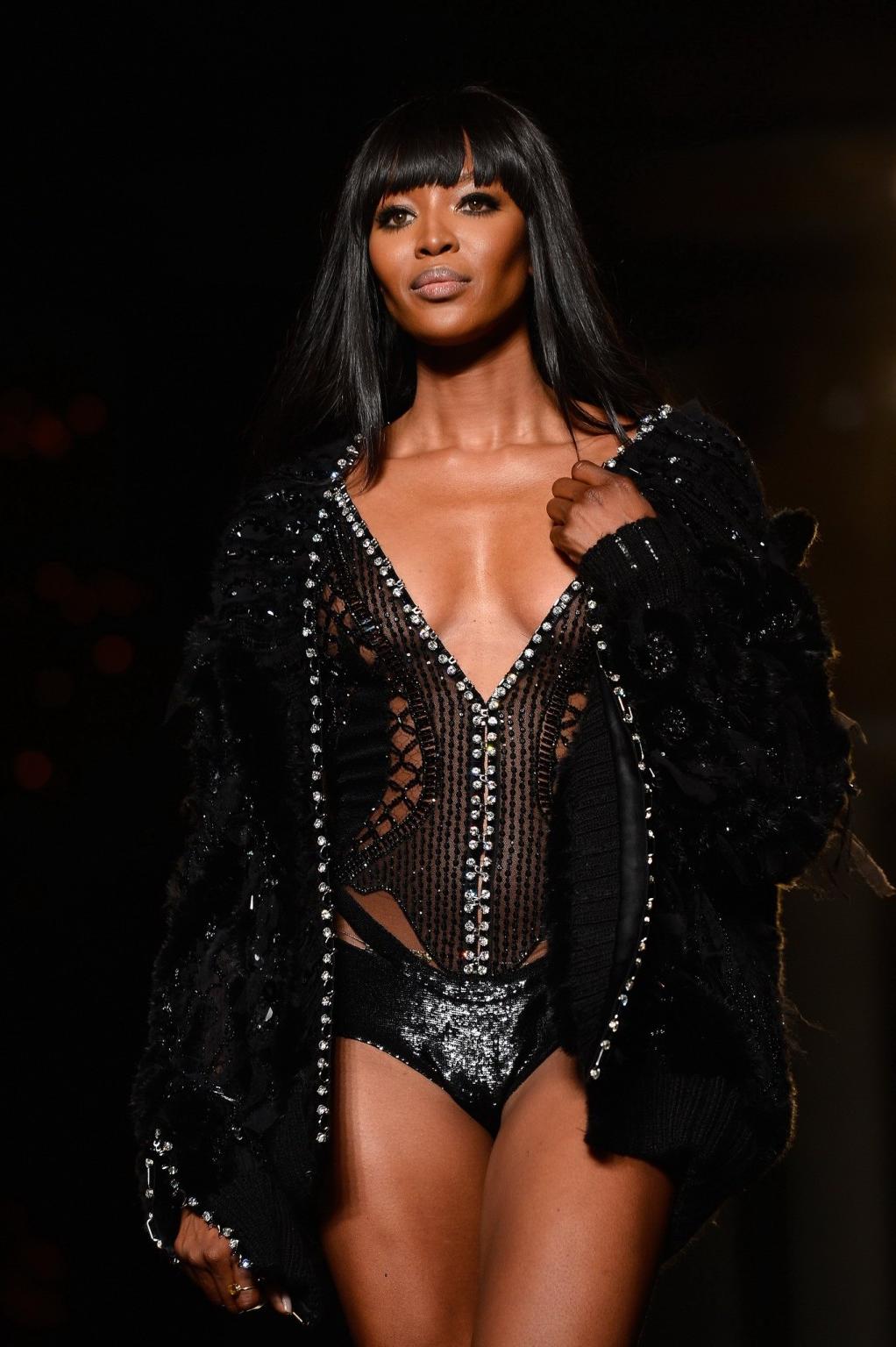 16P Naomi Campbell wearing black transparent lingerie on a catwalk during Versace sh