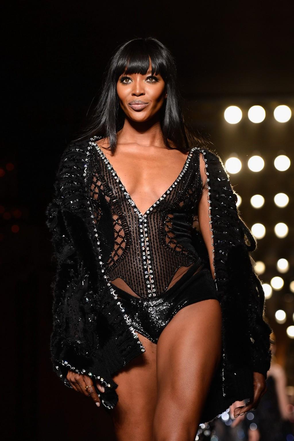 16P Naomi Campbell wearing black transparent lingerie on a catwalk during Versace sh
