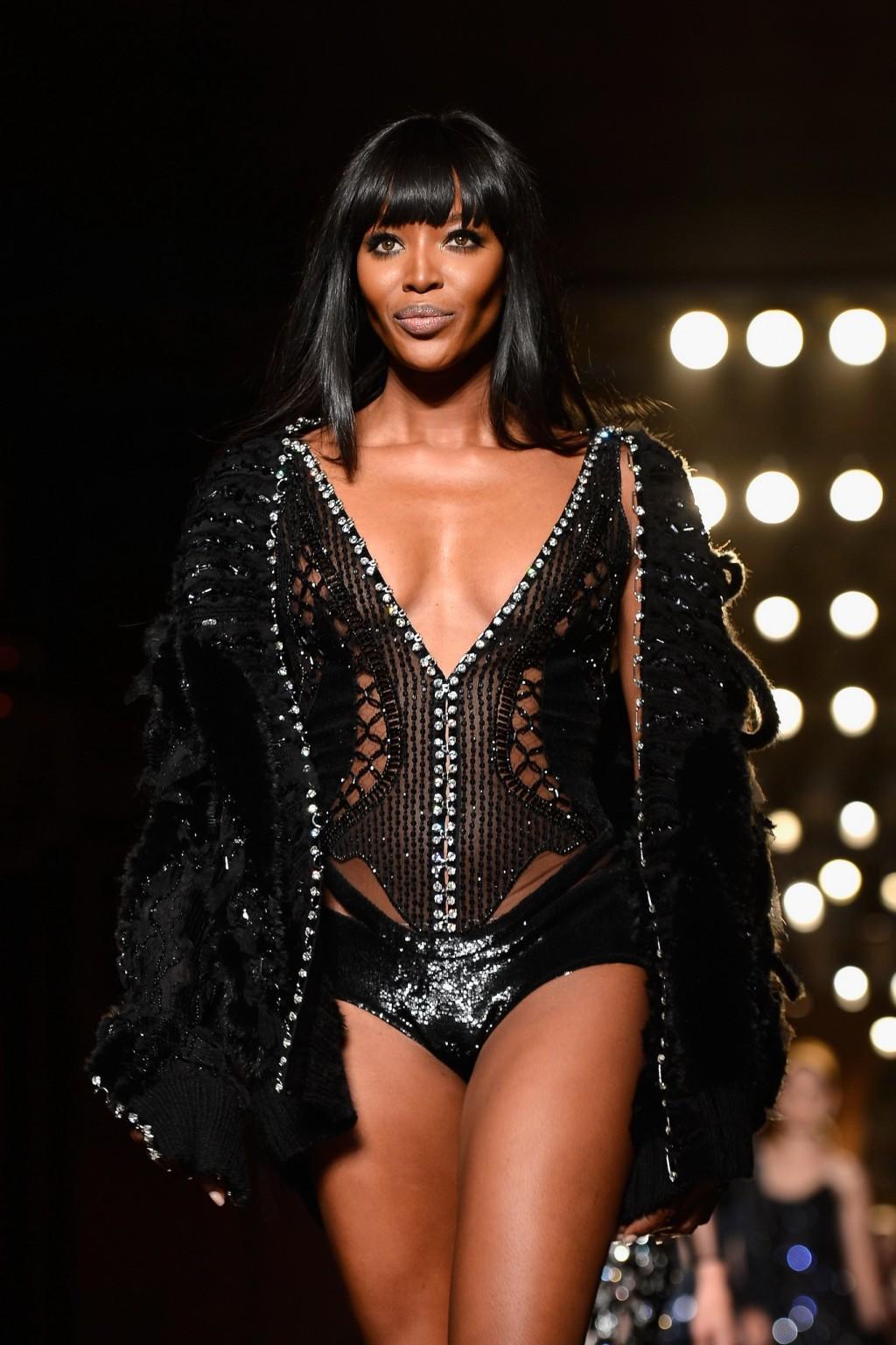 16P Naomi Campbell wearing black transparent lingerie on a catwalk during Versace sh