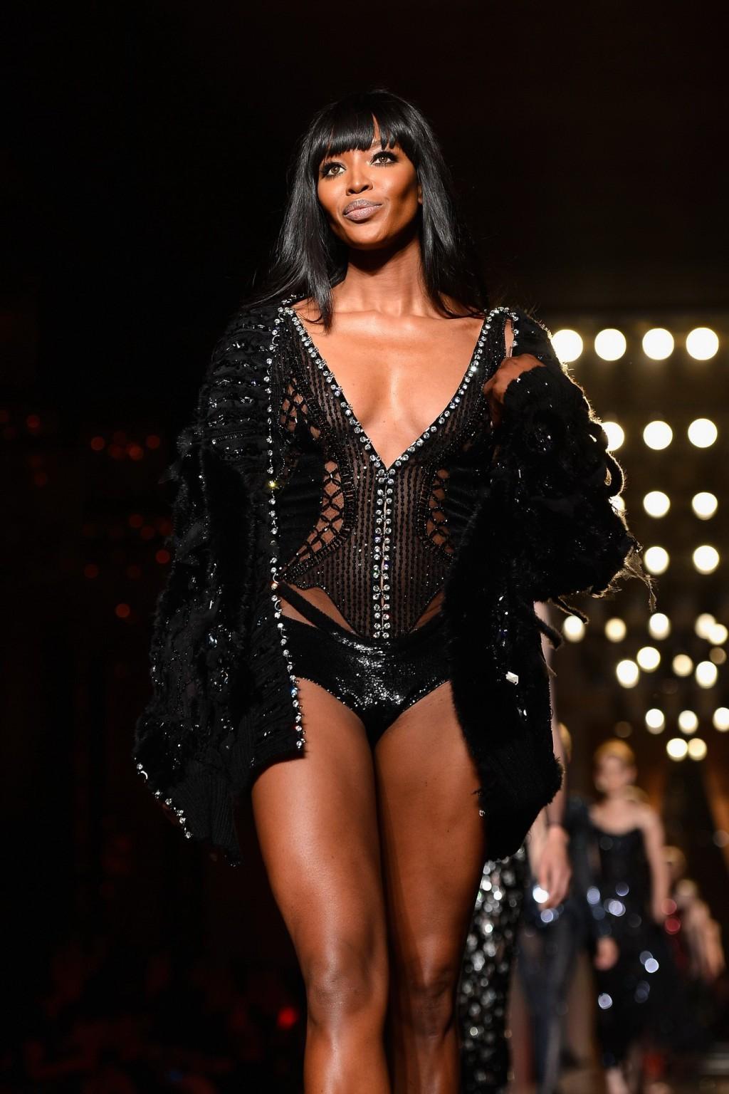 16P Naomi Campbell wearing black transparent lingerie on a catwalk during Versace sh