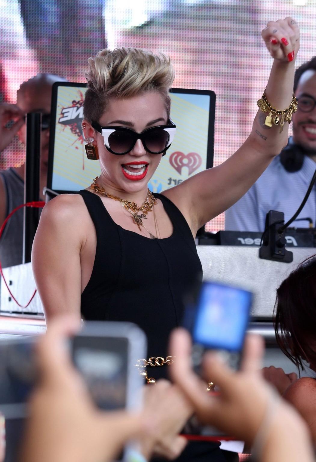 16P Miley Cyrus wearing tight black bodysuit at the Y100 Mack-A-Poolooza pool party 