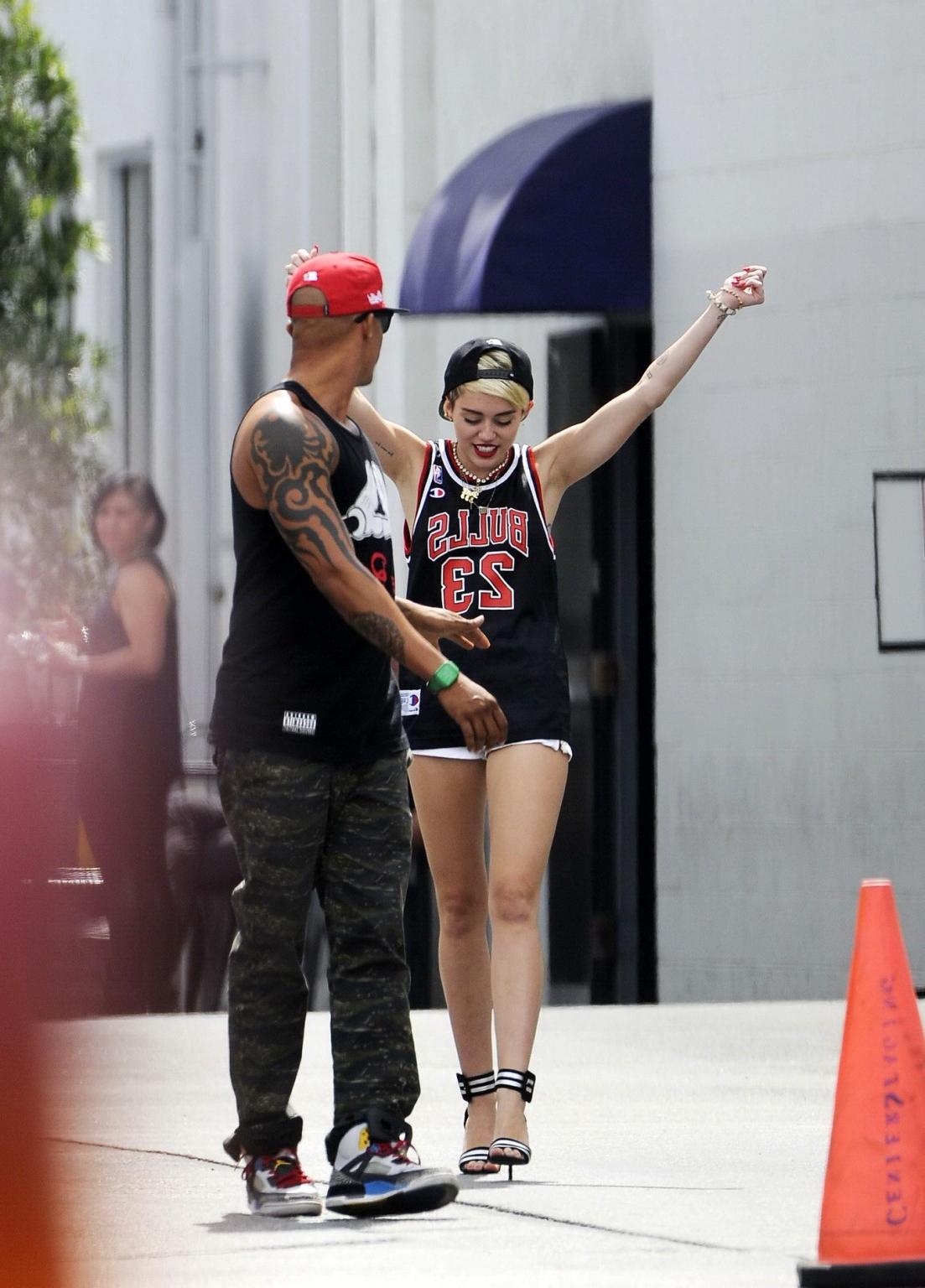 16P Miley Cyrus leggy wearing a shorts  a jersey outside a studio in LA
