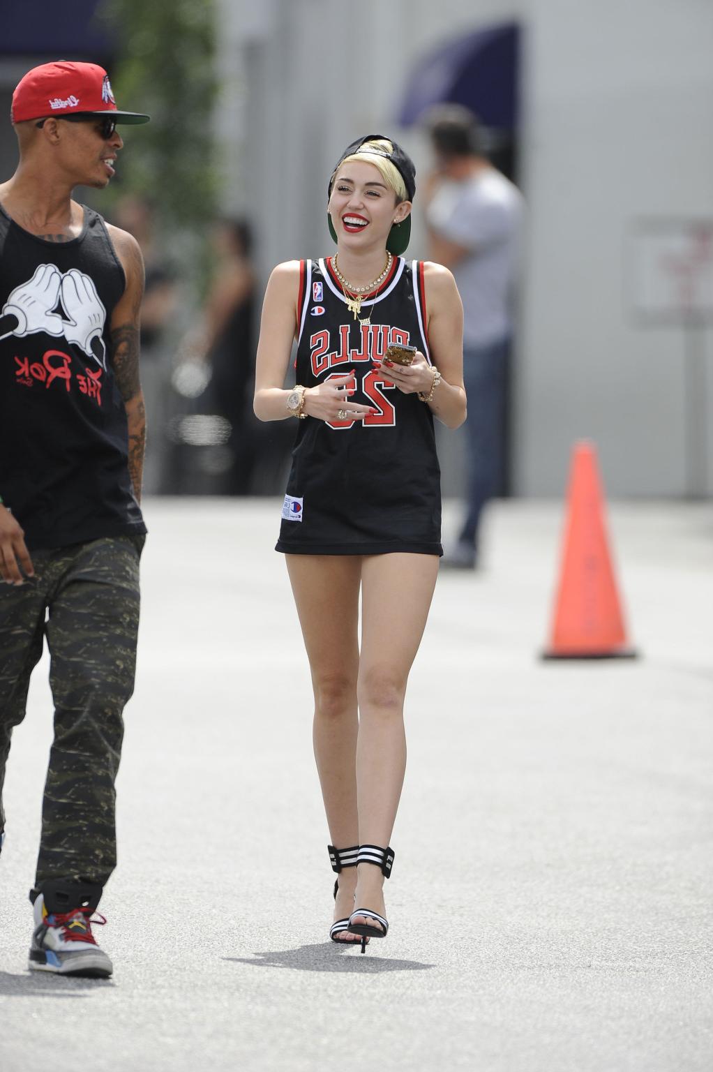 16P Miley Cyrus leggy wearing a shorts  a jersey outside a studio in LA