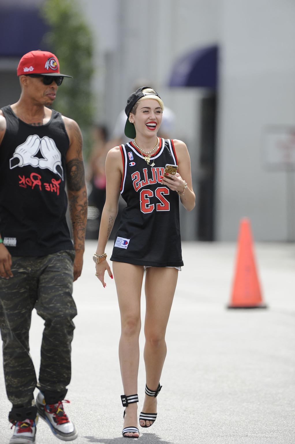 16P Miley Cyrus leggy wearing a shorts  a jersey outside a studio in LA