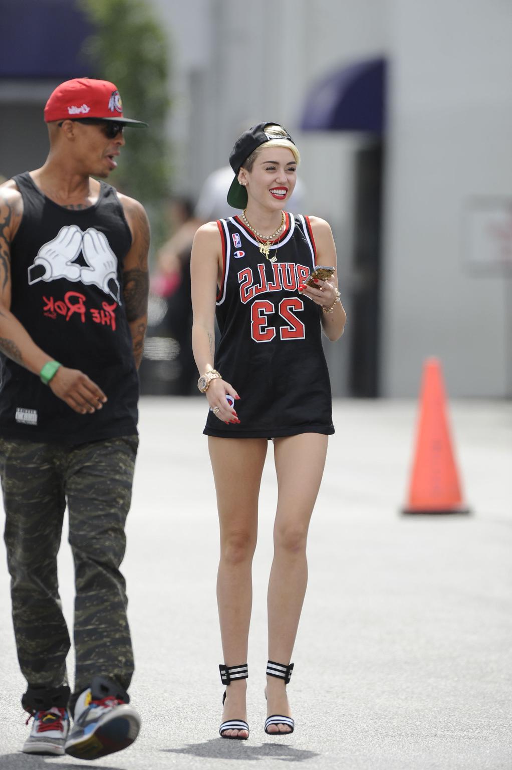 16P Miley Cyrus leggy wearing a shorts  a jersey outside a studio in LA