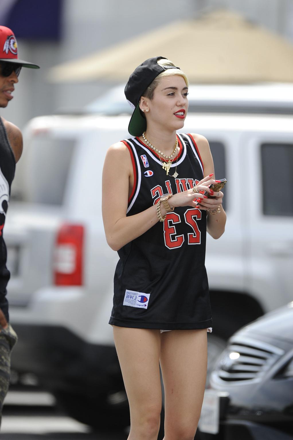 16P Miley Cyrus leggy wearing a shorts  a jersey outside a studio in LA