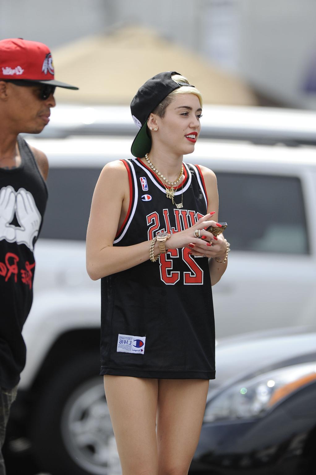 16P Miley Cyrus leggy wearing a shorts  a jersey outside a studio in LA