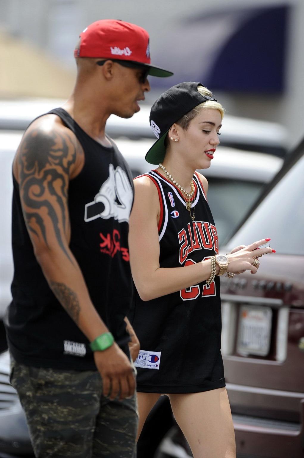 16P Miley Cyrus leggy wearing a shorts  a jersey outside a studio in LA