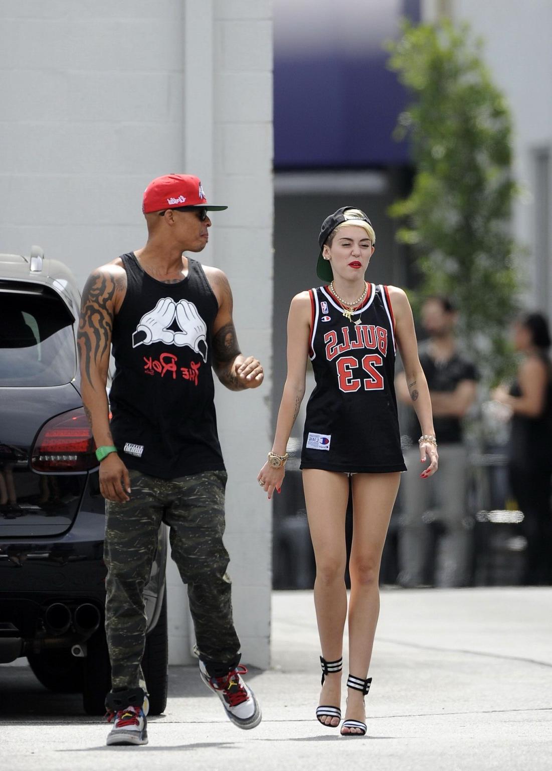 16P Miley Cyrus leggy wearing a shorts  a jersey outside a studio in LA
