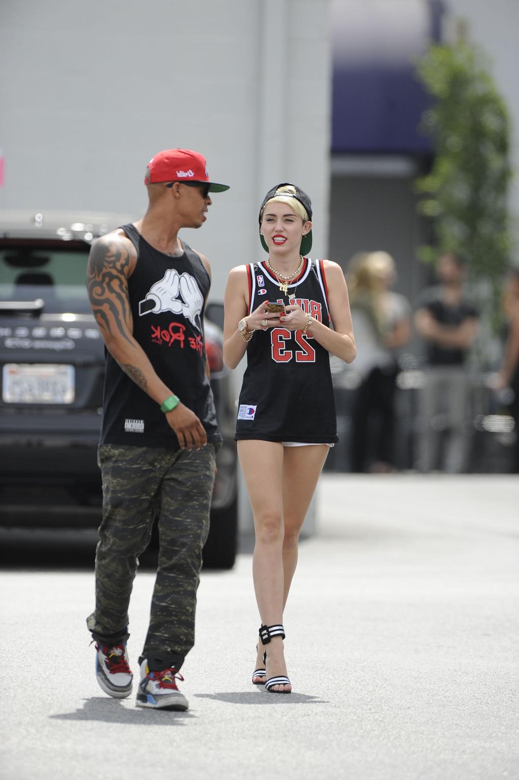 16P Miley Cyrus leggy wearing a shorts  a jersey outside a studio in LA