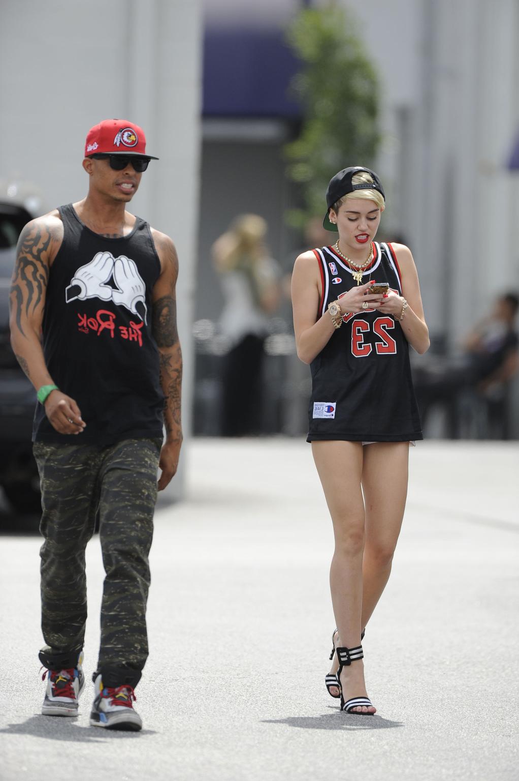 16P Miley Cyrus leggy wearing a shorts  a jersey outside a studio in LA
